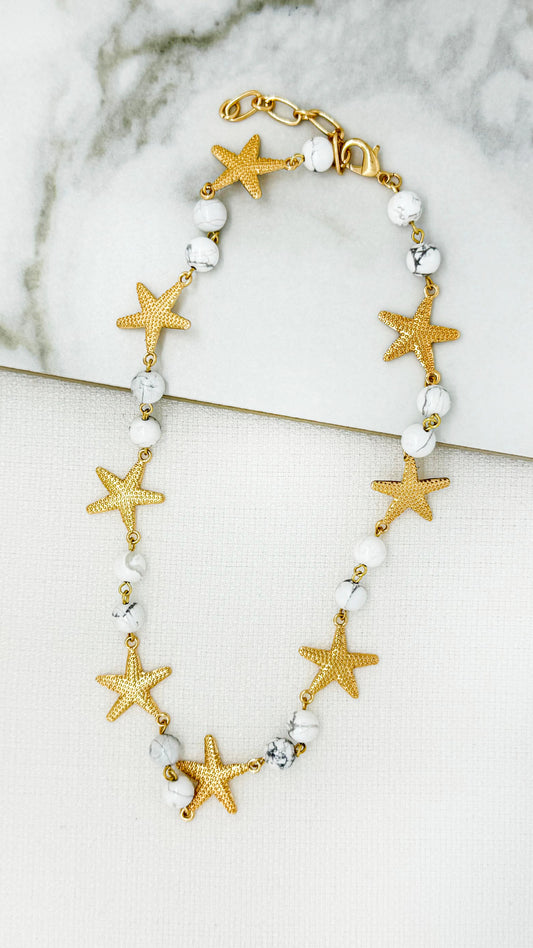 Short white bead necklace with gold starfish pendant