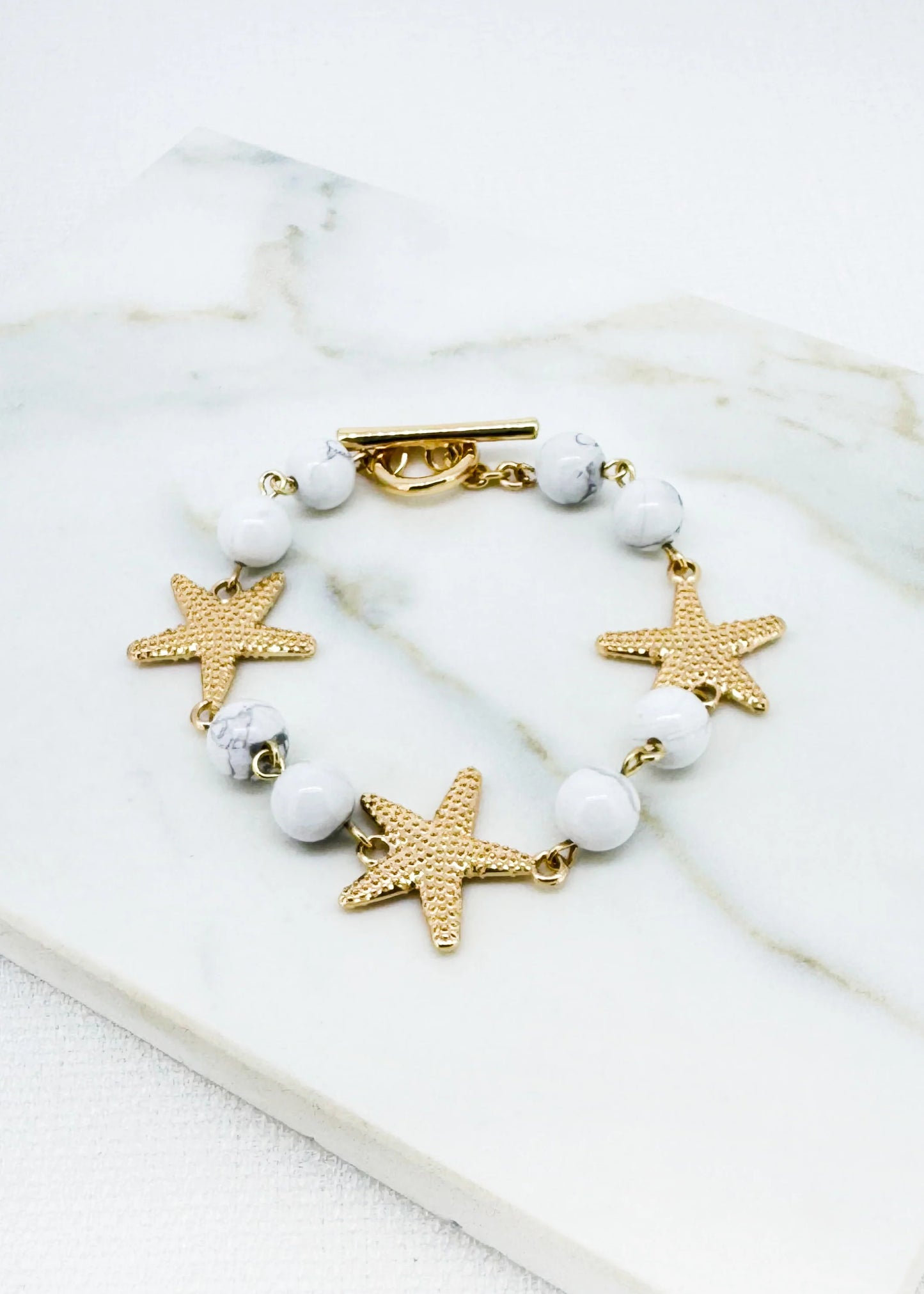 White bead and gold T-bar bracelet with starfish