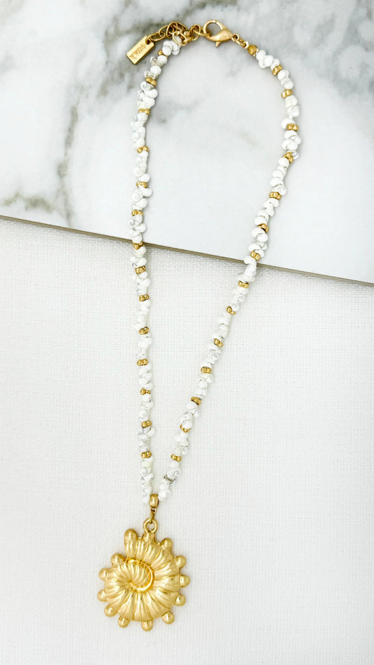 Short gold and white bead design necklace with fossil pendant