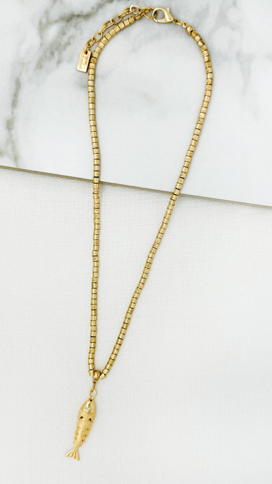 Short worn gold necklace with fish pendant