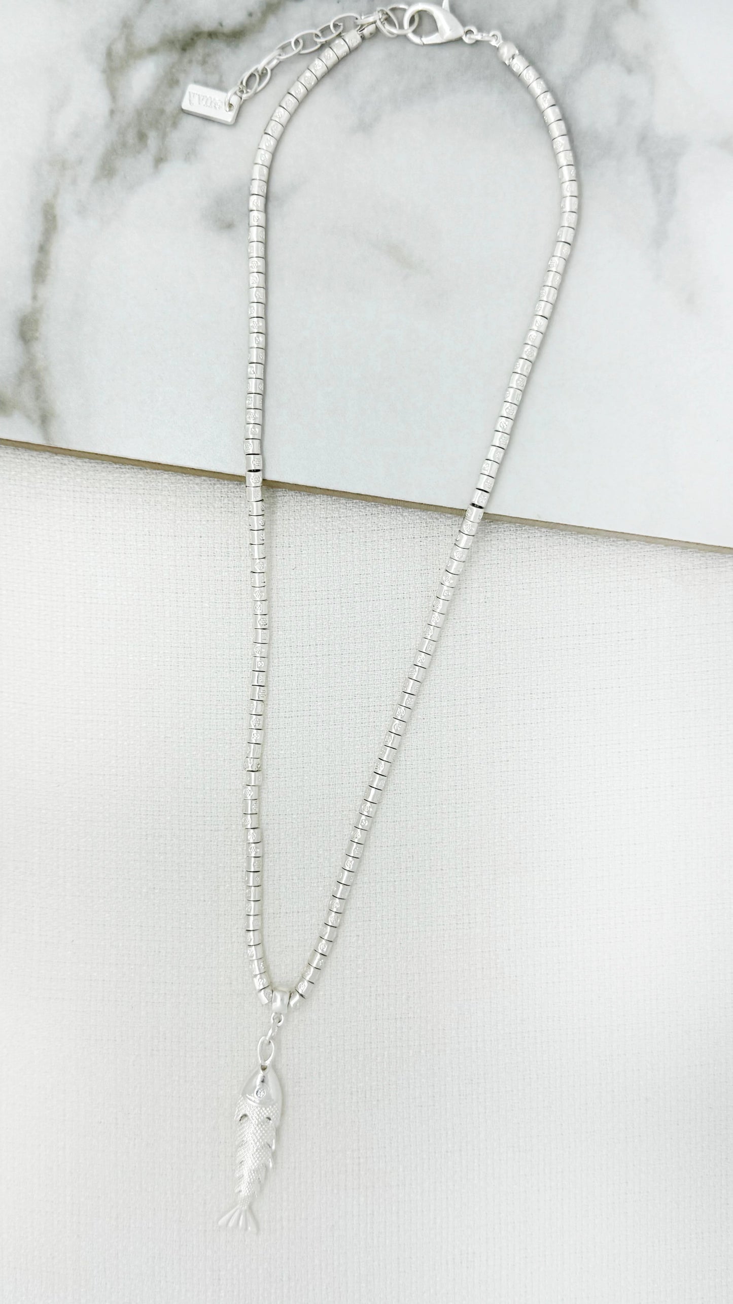 Short worn silver necklace with fish pendant
